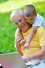 Image showing grandfather and child using laptop