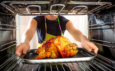 Image showing Cooking chicken in the oven at home.