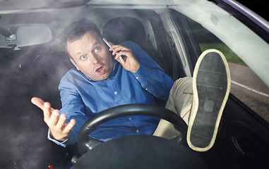 Image showing Driver and cellphone