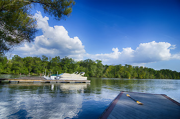 Image showing boats at dock on a lake with blue sky