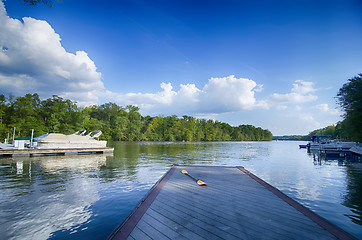 Image showing boats at dock on a lake with blue sky