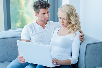 Image showing Concerned young couple using a laptop computer