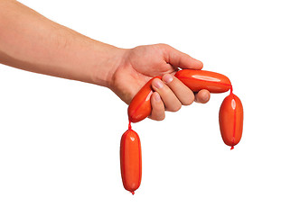 Image showing Hand with sausage