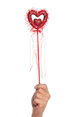 Image showing Hand with heart on a stick