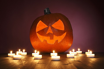 Image showing Pumpkin on a red background with candles