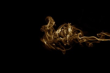 Image showing Golden smoke on black background