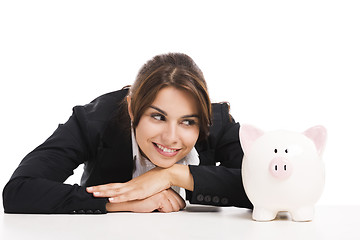 Image showing Businesswoman with a piggy bank