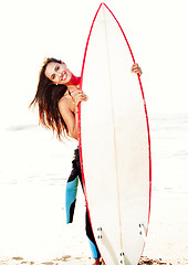 Image showing Surfer girl with her surfboard