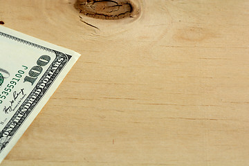 Image showing One hundred dollars on wood background