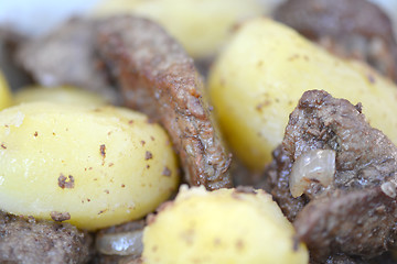 Image showing Mixed grill on a plate, meat and potatoes