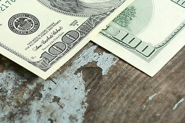 Image showing Close-up of a $100 banknotes on wooden background