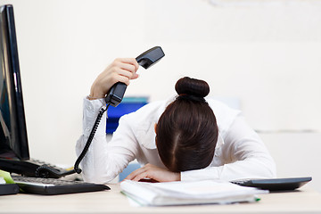 Image showing Young attractive business woman with phone in hand