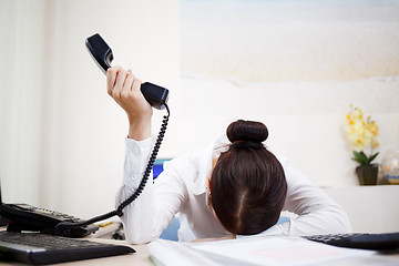 Image showing Young attractive business woman with phone in hand