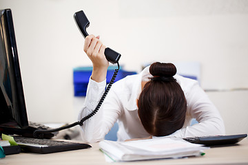 Image showing Young attractive business woman with phone in hand