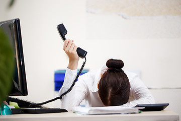 Image showing Young attractive business woman with phone in hand