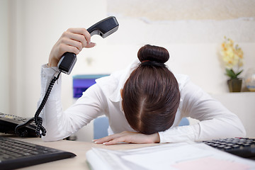 Image showing Young attractive business woman with phone in hand