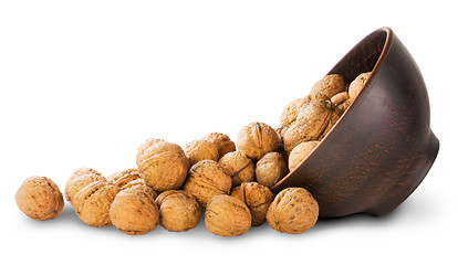 Image showing Walnuts Spill Out Of A Clay Bowl