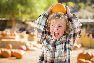 Image showing Little Boy Holding His Pumpkin at a Pumpkin Patch