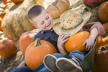 Image showing Two Little Boys Playing in Wheelbarrow at the Pumpkin Patch