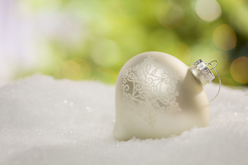 Image showing White Christmas Ornament on Snow Over an Abstract Background