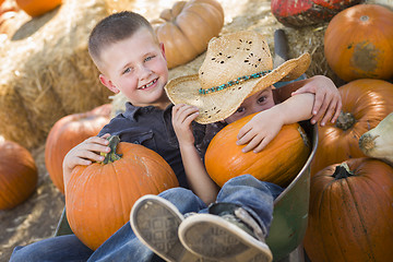 Image showing Two Little Boys Playing in Wheelbarrow at the Pumpkin Patch