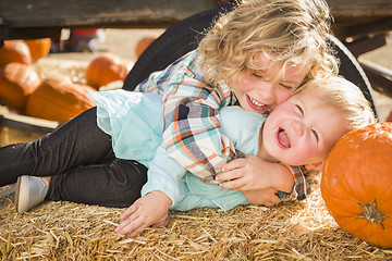 Image showing Little Boy Playing with His Baby Sister at Pumpkin Patch