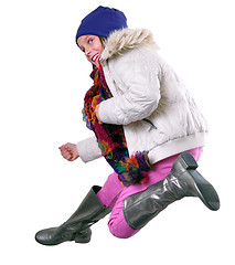 Image showing isolated autumn portrait of child with hat, scarf and boots jumping 