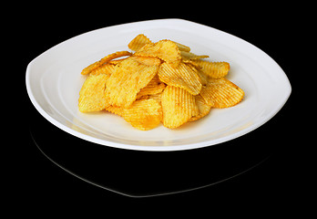 Image showing Potato chips on a plate on a black background