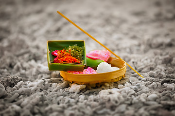 Image showing Offerings to gods in Bali with flowers, rice and aroma stick