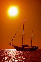 Image showing Silhouette of sailing yacht in the tropical sea at sunset. Thail