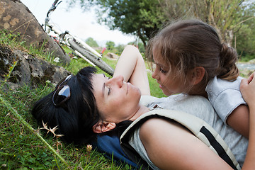 Image showing Mother and daughter relaxing on a grass