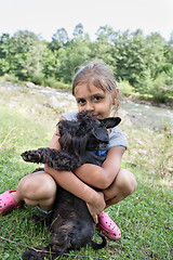 Image showing Little girl and her puppy