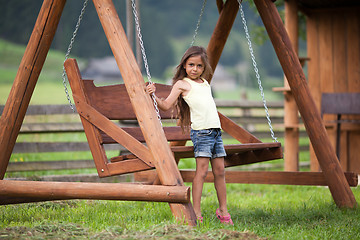 Image showing Little girl and swing