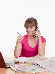 Image showing Girl talking on the phone to a newspaper ad