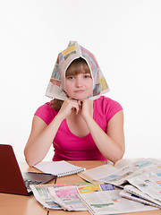 Image showing The girl wore a newspaper as headscarf