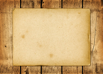 Image showing Blank vintage paper sheet on a wood board