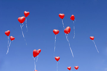 Image showing Red balloon hearts in the sky