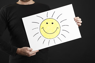 Image showing Man holding billboard with sun