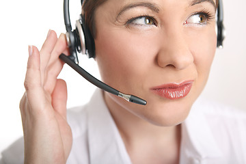 Image showing Young woman with headset has problems to understand the caller