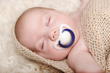 Image showing Sleeping baby lying on a blanket