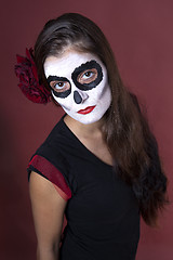Image showing Woman with makeup of la Santa Muerte with red roses