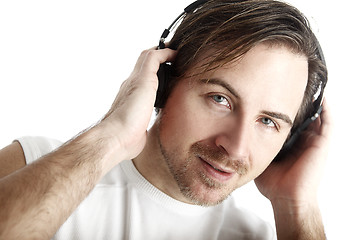 Image showing Attractive man with headphones in front of a white background lo