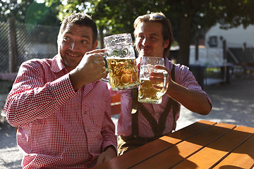 Image showing Two Bavarians sitting in a beer garden 