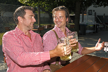 Image showing Two Bavarians sitting in a beer garden 