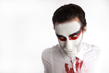 Image showing Man with white mascara and bloody shirt