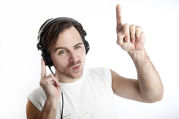 Image showing Attractive man with headphones in front of a white background da