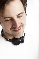 Image showing Attractive man with headphones in front of a white background