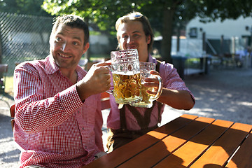 Image showing Two Bavarians sitting in a beer garden 