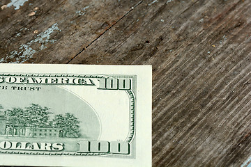 Image showing Close-up of a $100 banknotes on wooden background