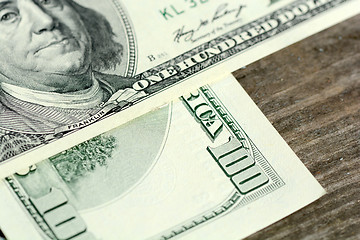 Image showing One hundred dollars on wood background